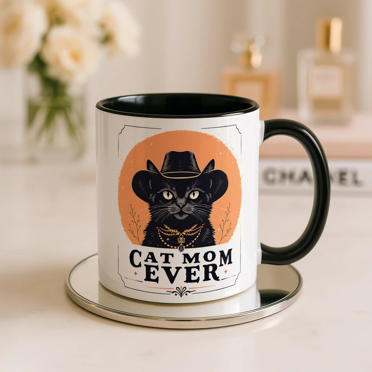 Mug with a cat wearing a cowboy hat and 'Cat Mom Ever' text on a table.