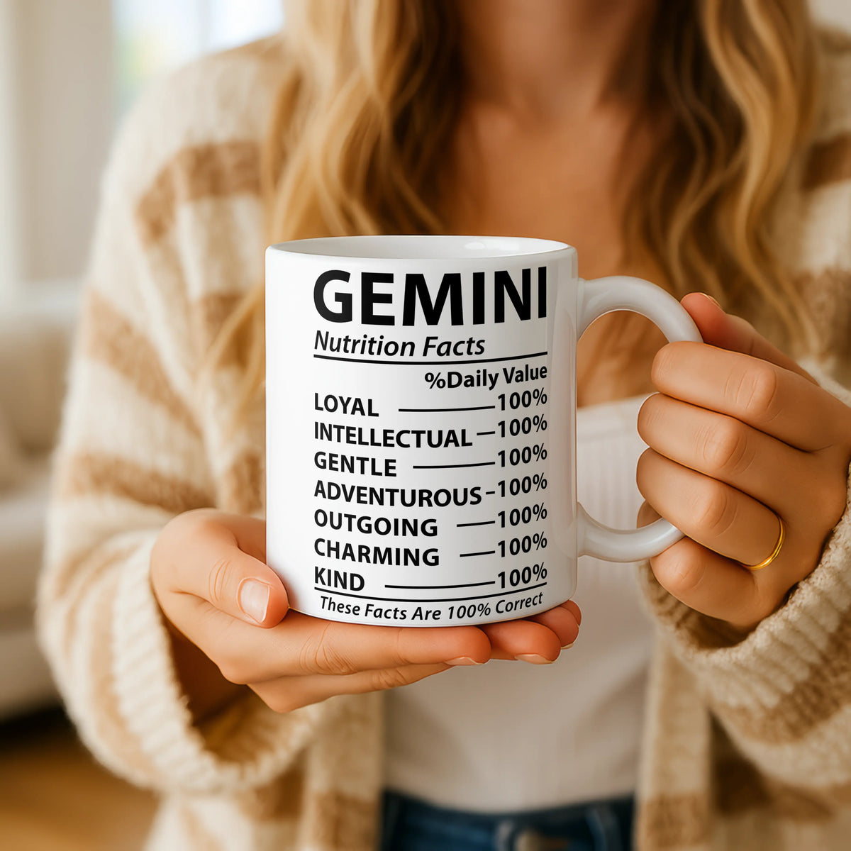 Person holding a mug with 'Gemini Nutrition Facts' text
